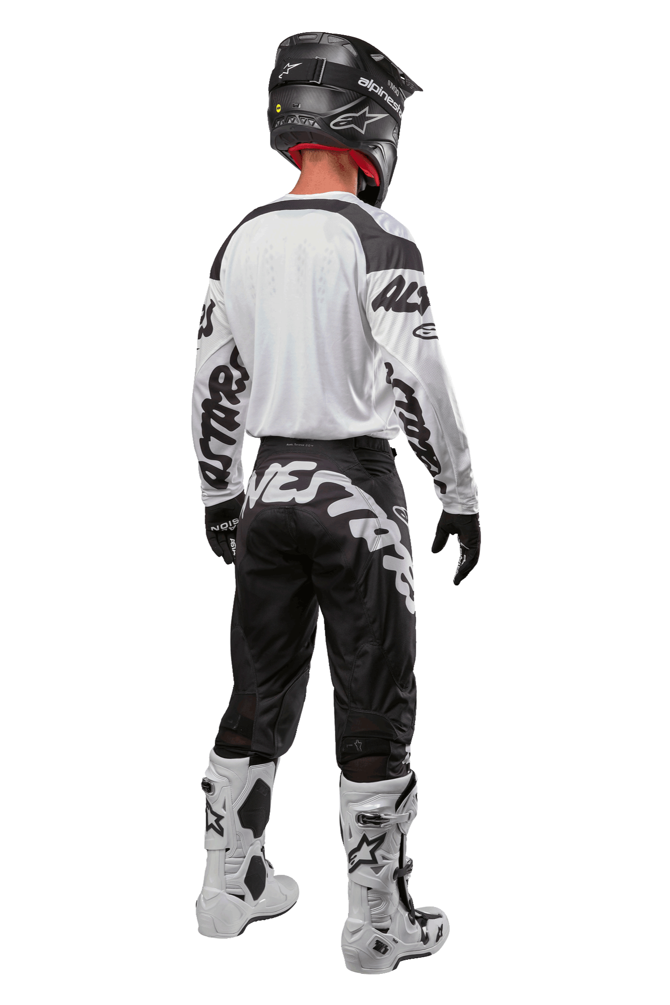 Alpinestars 2024 Racer Hana Pants, motorcross broek in zwart en wit, achteraanzicht, persoon draagt een volledige motorcross uitrusting met bijpassende jersey, helm en laarzen, sportief ontwerp voor terreinrijden