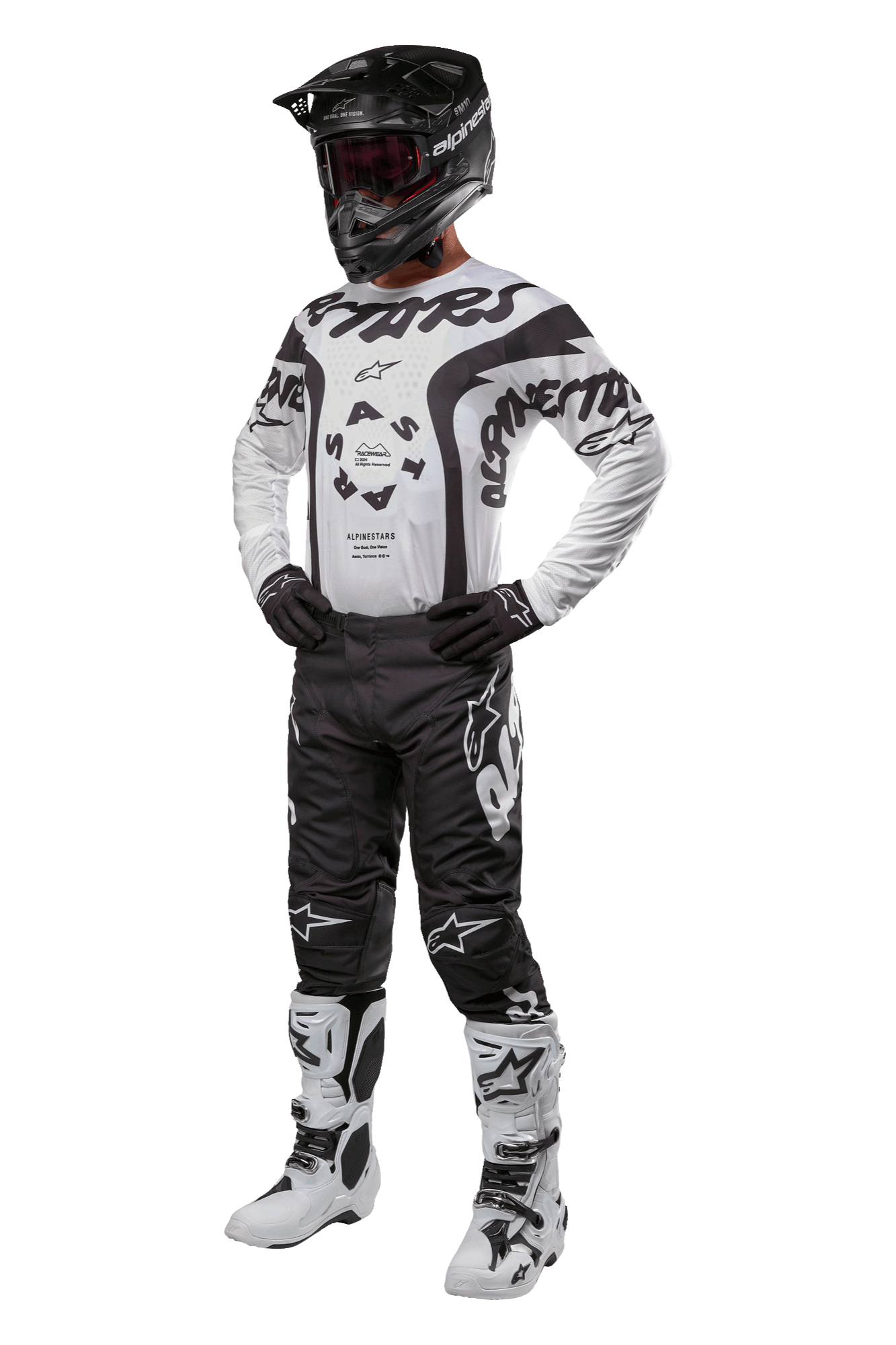 Alpinestars 2024 Racer Hana motorcross outfit, compleet racetenue met helm, jersey, broek, handschoenen en laarzen, zwart en wit met grafische patronen, persoon draagt volledige uitrusting voor terreinrijden