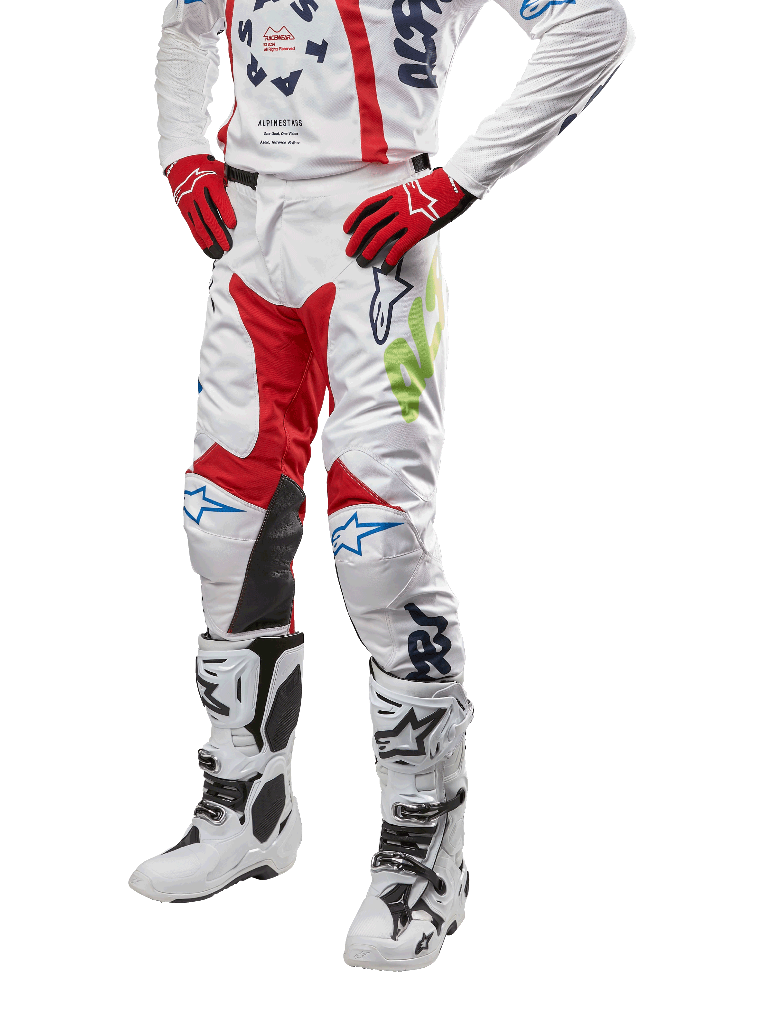 Alpinestars 2024 Racer Hana broek, motorcross racebroek, wit met rode, blauwe en limoengroene accenten, beschermend ontwerp met leren kniepanelen, gedragen met bijpassende jersey, rode handschoenen en witte laarzen met gespen, sportieve motorsportoutfit