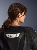 Alpinestars Stella GP-R7 2-delig leren pak, zwart, close-up van de achterkant met het GP-R7-logo op de aerodynamische bult, lederen accordeon stretchpanelen op de schouders, hoogwaardige raceconstructie voor dames