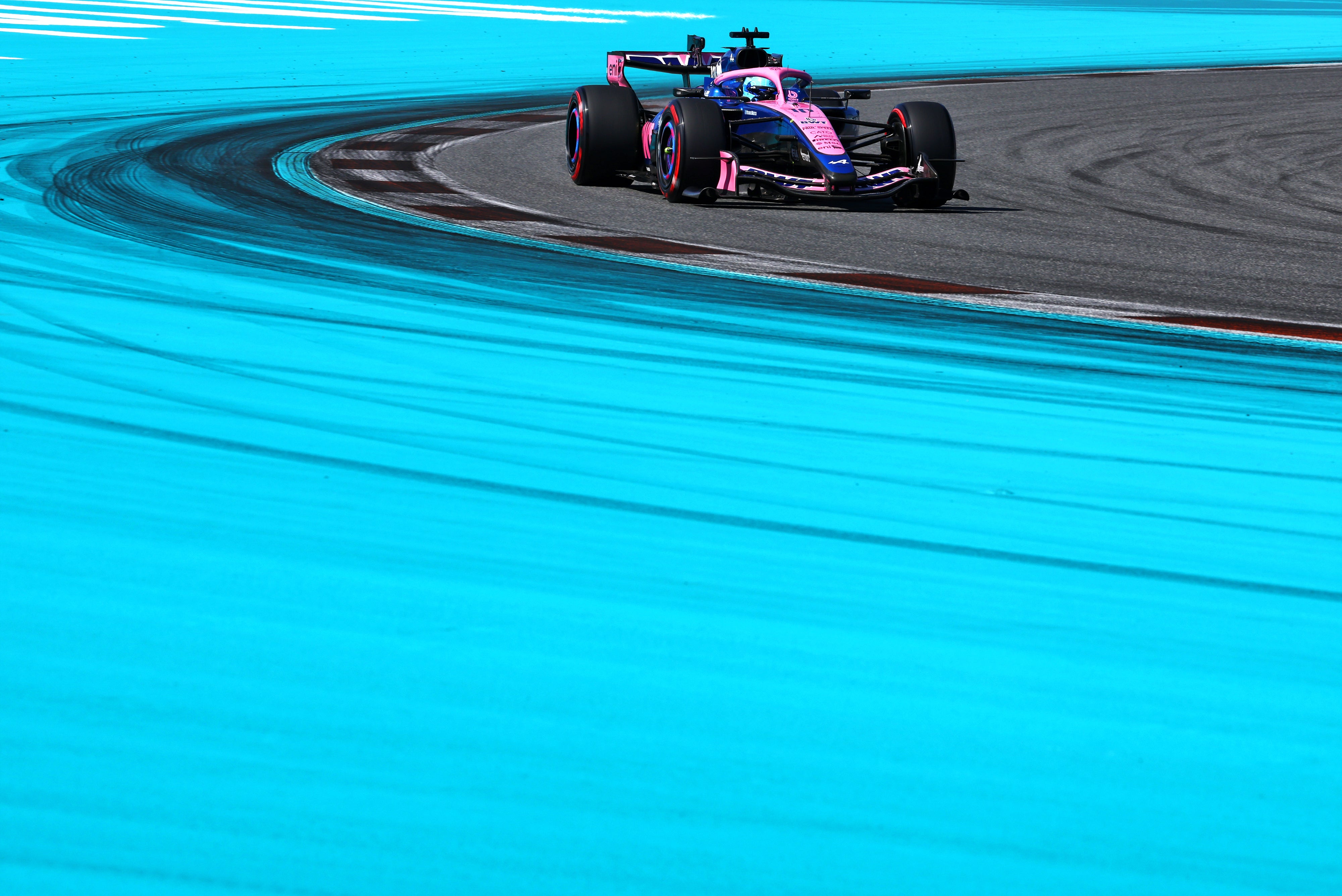 Alpine Formula 1 car on a racetrack with a blue track surface
