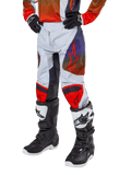 Alpinestars 2024 Youth Racer Hoen Pants, Motocross Pants, Light Gray with Hot Orange and Black accents, featuring red star logos on thighs and red knee panels, worn with black and white boots, durable design for off-road racing