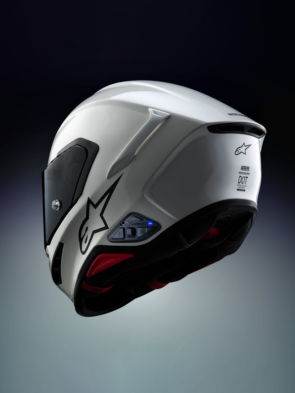 Alpinestars A-Connect communicatiesysteem geïnstalleerd op een Alpinestars S-R7 motorhelm, wit en zwart, voorzien van Mesh 3.0-intercom en Bluetooth 5.3-regeleenheid met actief blauw led-statuslampje