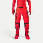 Alpinestars Supertech Ember LE Pants, Motocross Pants, Red Fluo and Bright Red with Black accents, featuring bold black star logos on the thighs, black waist buckle and knee panels, worn with matching red boots and gloves for a coordinated racing outfit.