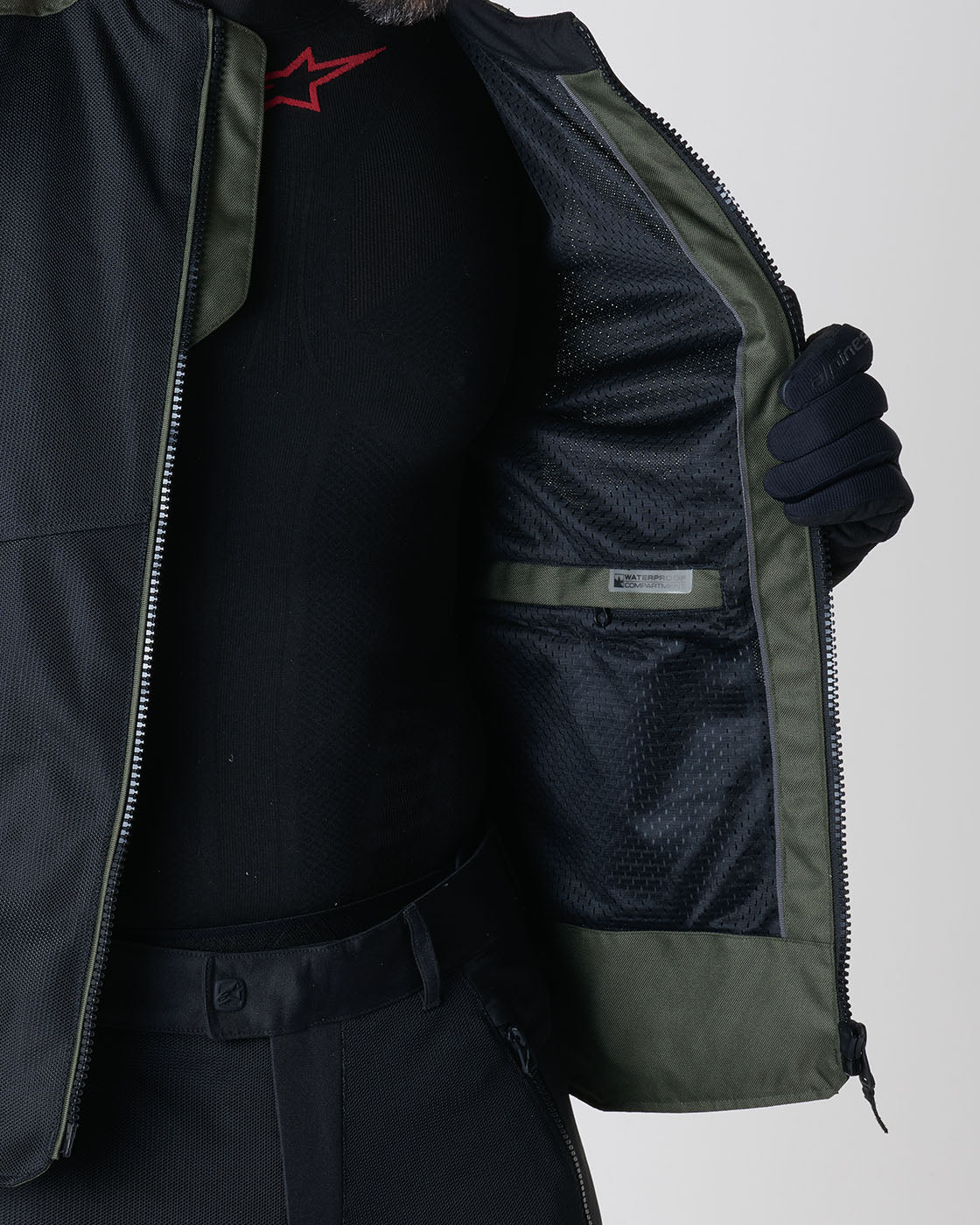 Alpinestars C-1 Air Jacket, Men's Urban Motorcycle Jacket, Green and Black textile, showing the internal waterproof compartment.