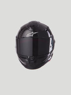 Alpinestars S-R7 Solid Helmet, Motorcycle Racing Helmet, Glossy Black, Carbon Composite Construction, ECE 22.06 Certified, featuring white Alpinestars logo and tinted visor